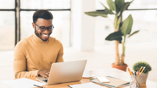 man smiling with laptop