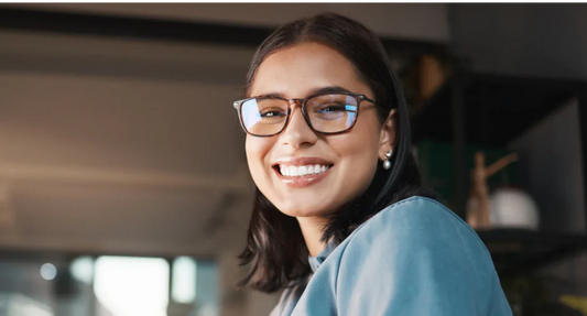 woman with glasses smiling